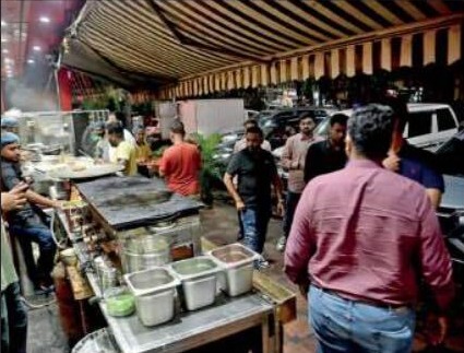 Customers at a street food stall in Swimming Pool Para
